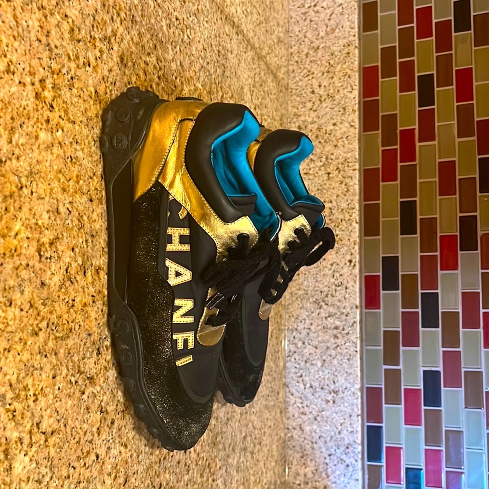 black, gold, and teal chanel sneakers